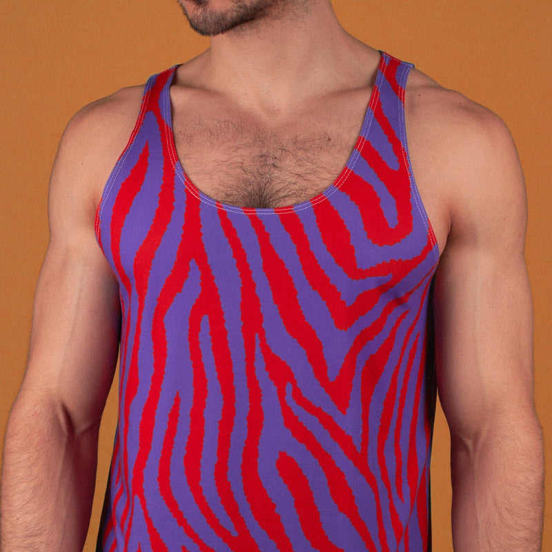 muscular man wearing a red and purple zebra print gym tank 